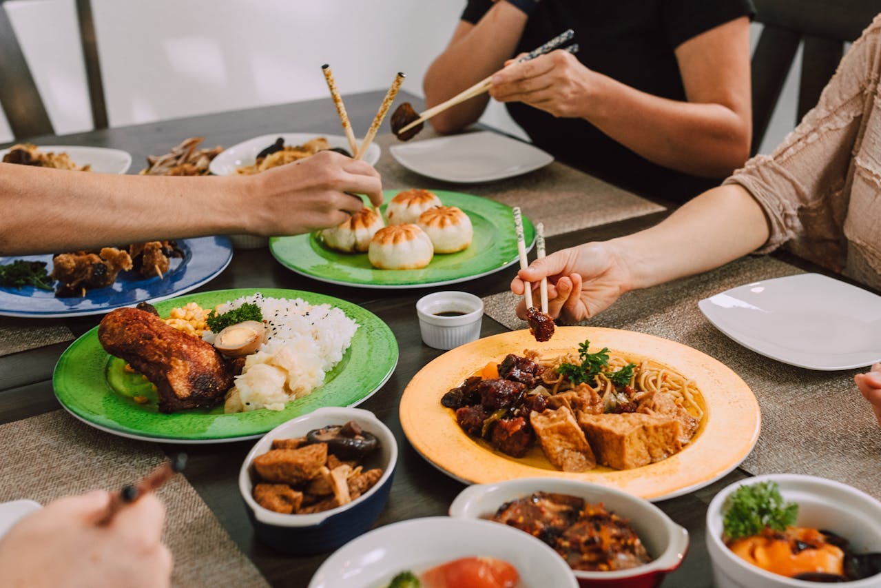 People eating different Asian dishes