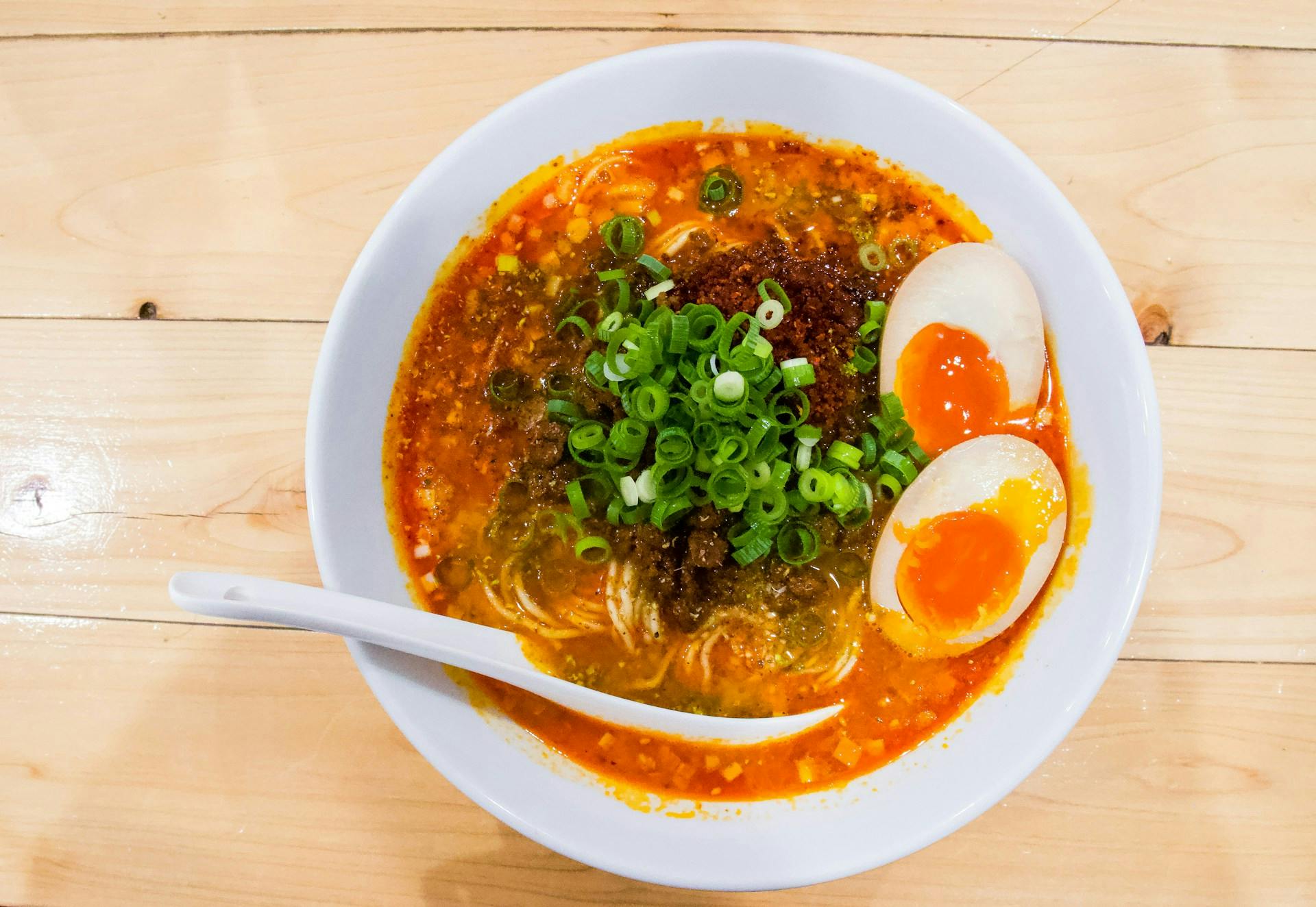Ramen with red sauce, eggs and spring onions