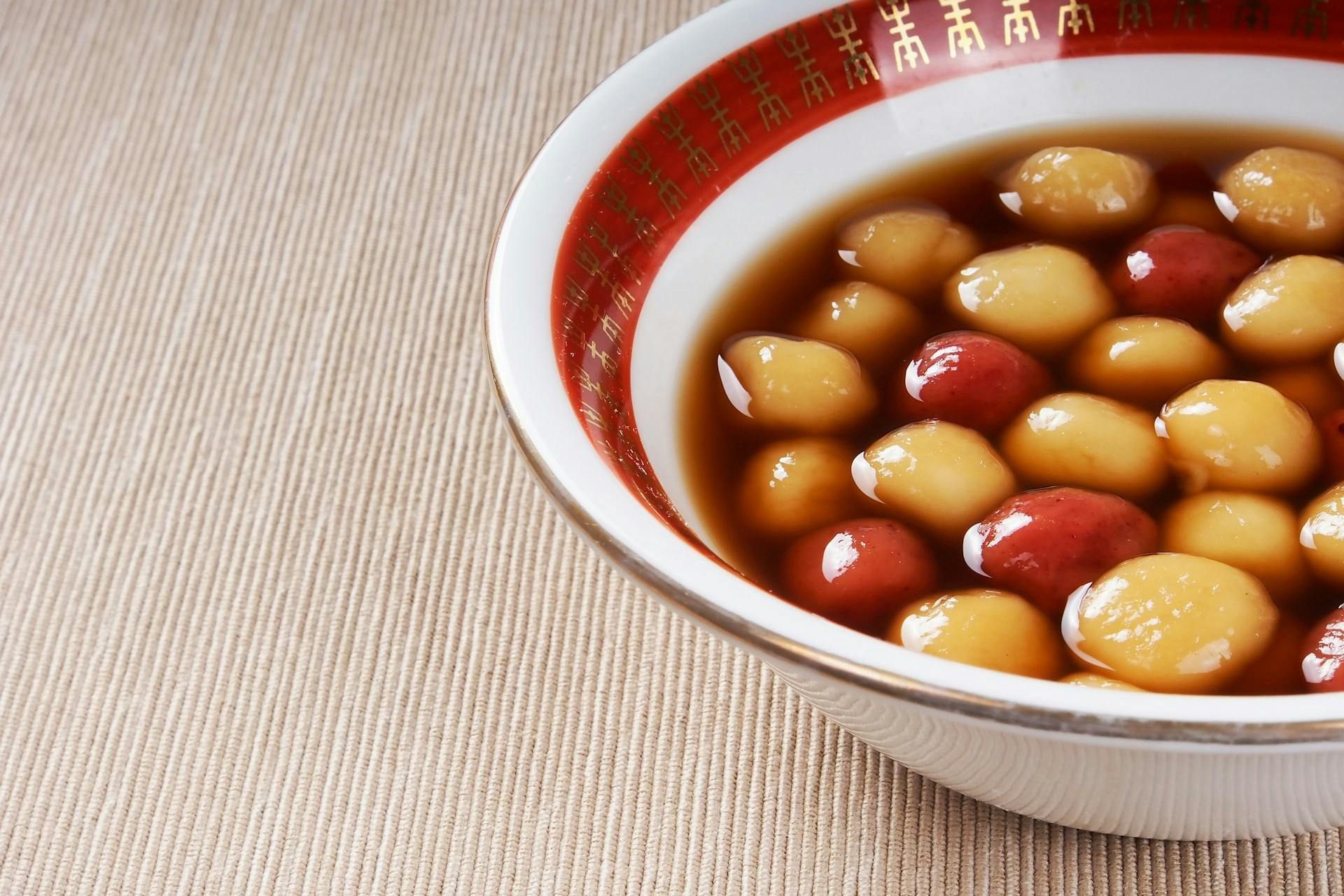 Red and white tangyuan in a bowl