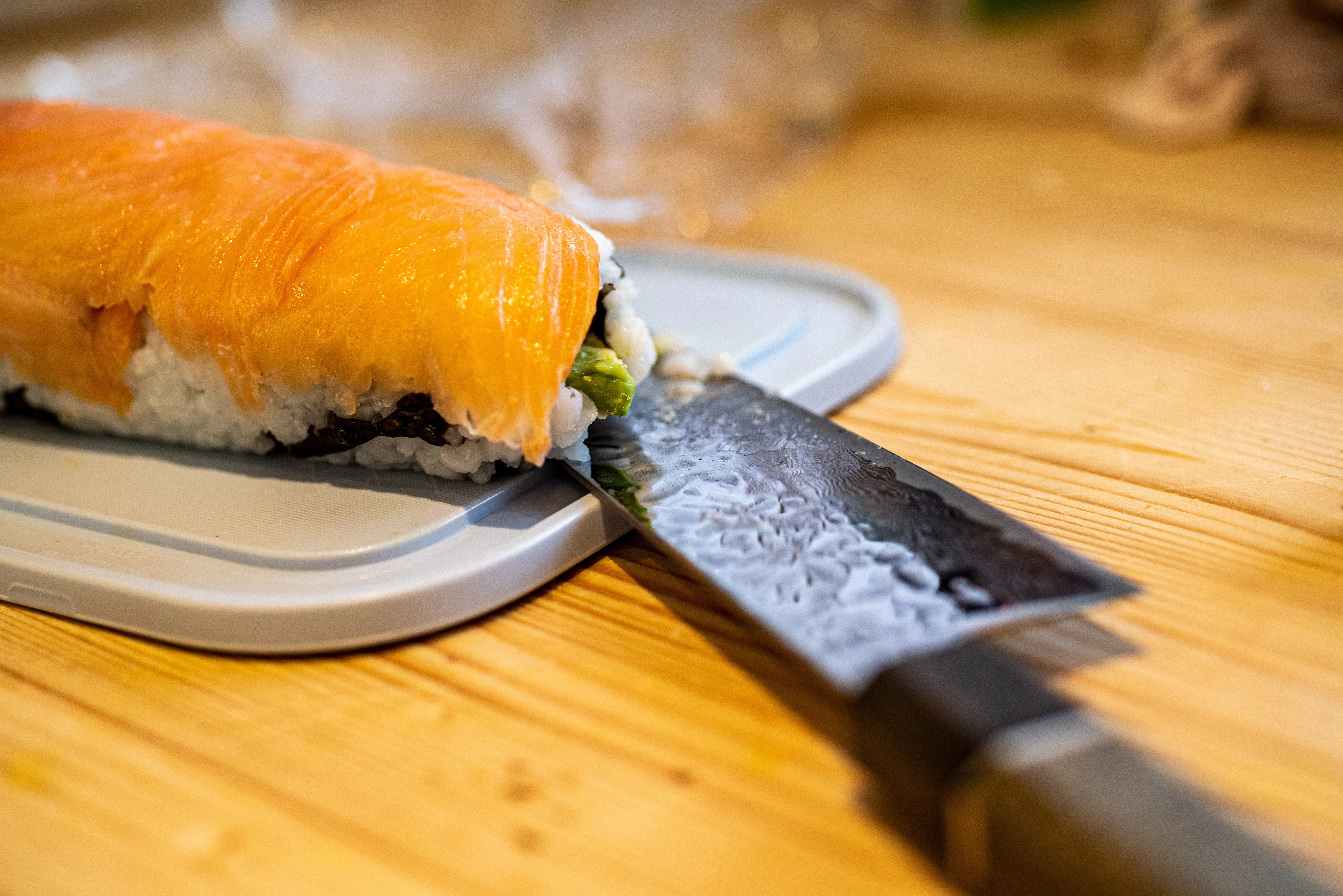 Japanese knife and sushi on a wooden table