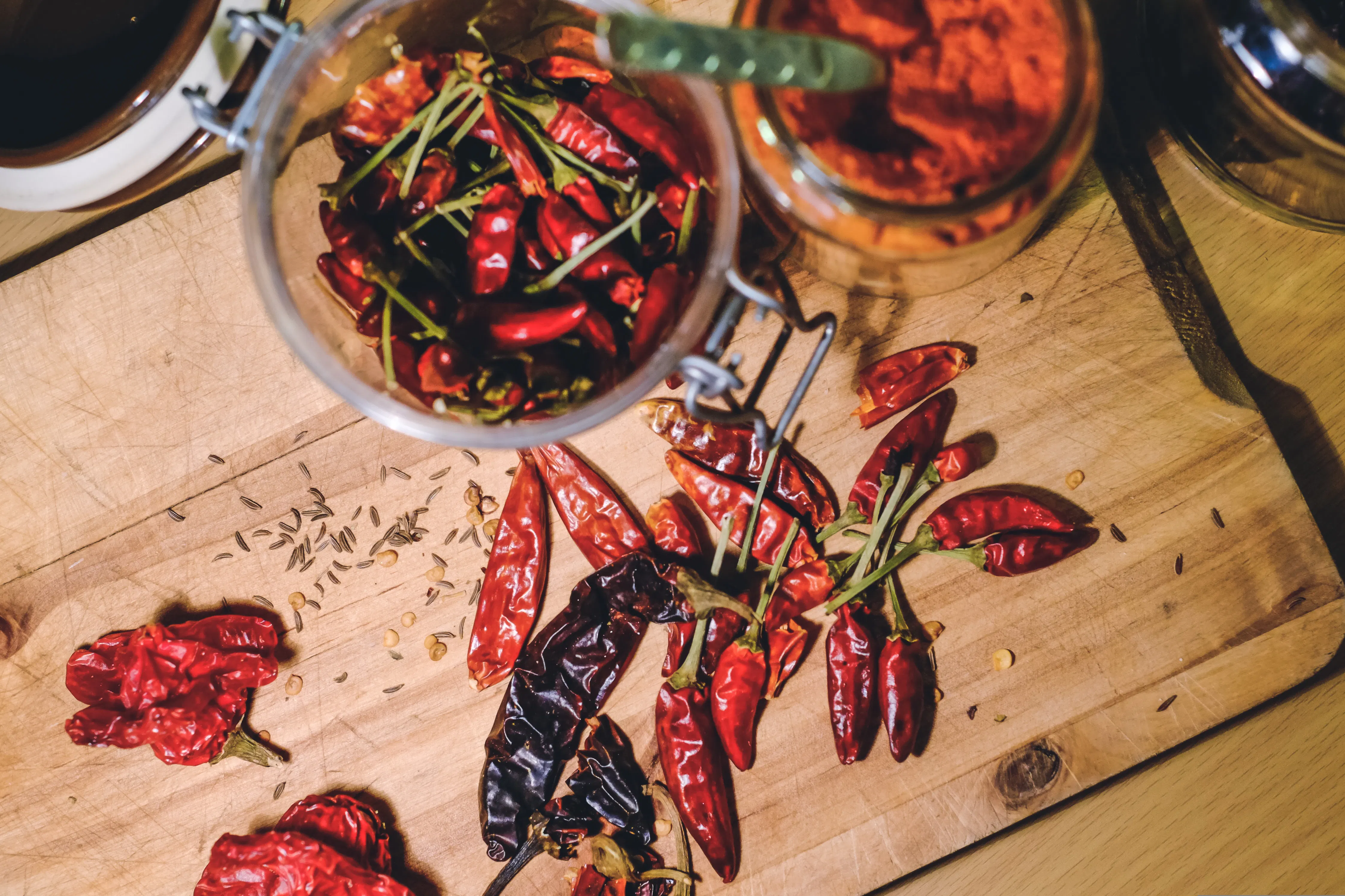 Dried chilli and chilli powder on a chopping board