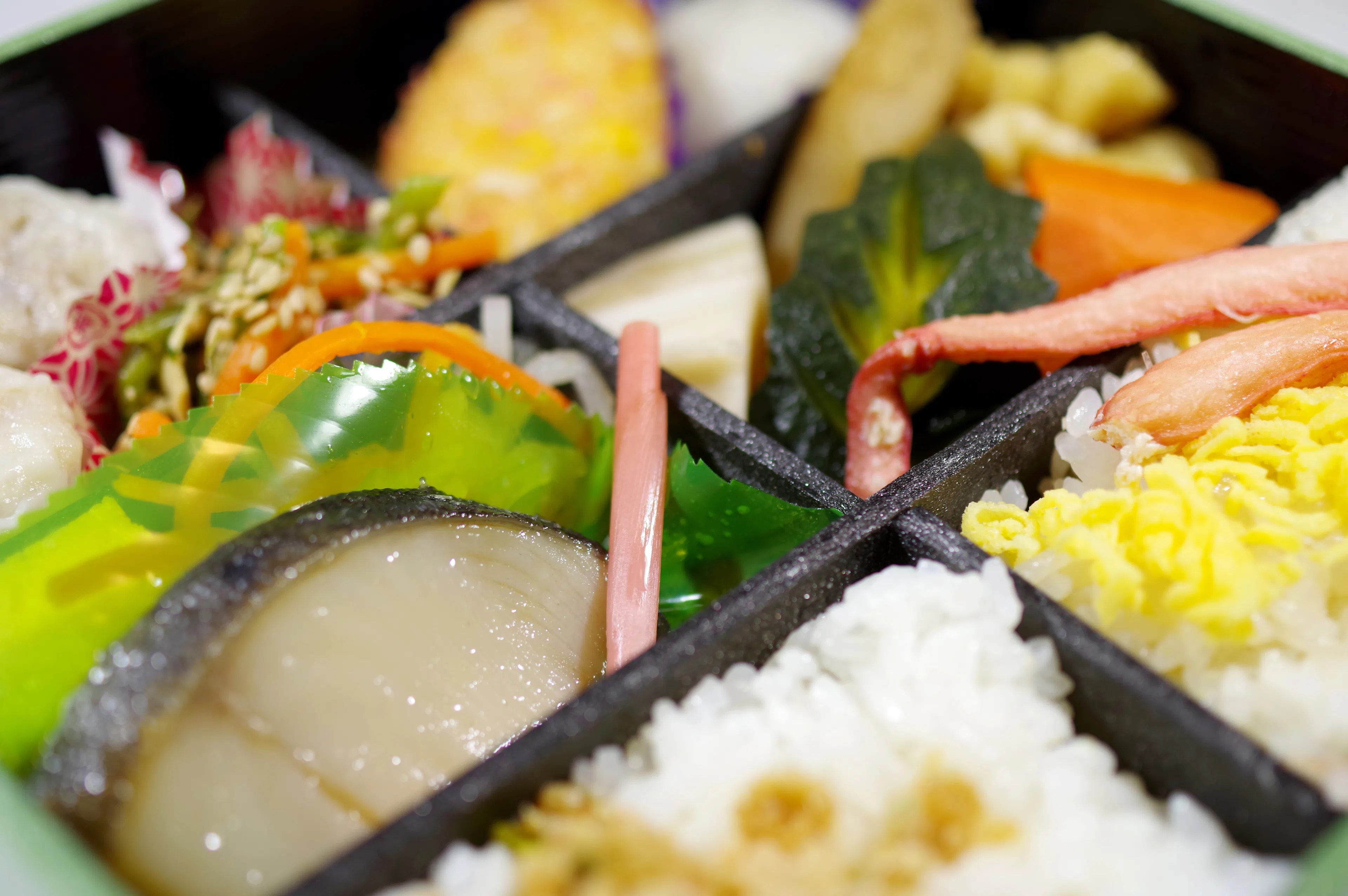 A bento box filled with pickles and rice.