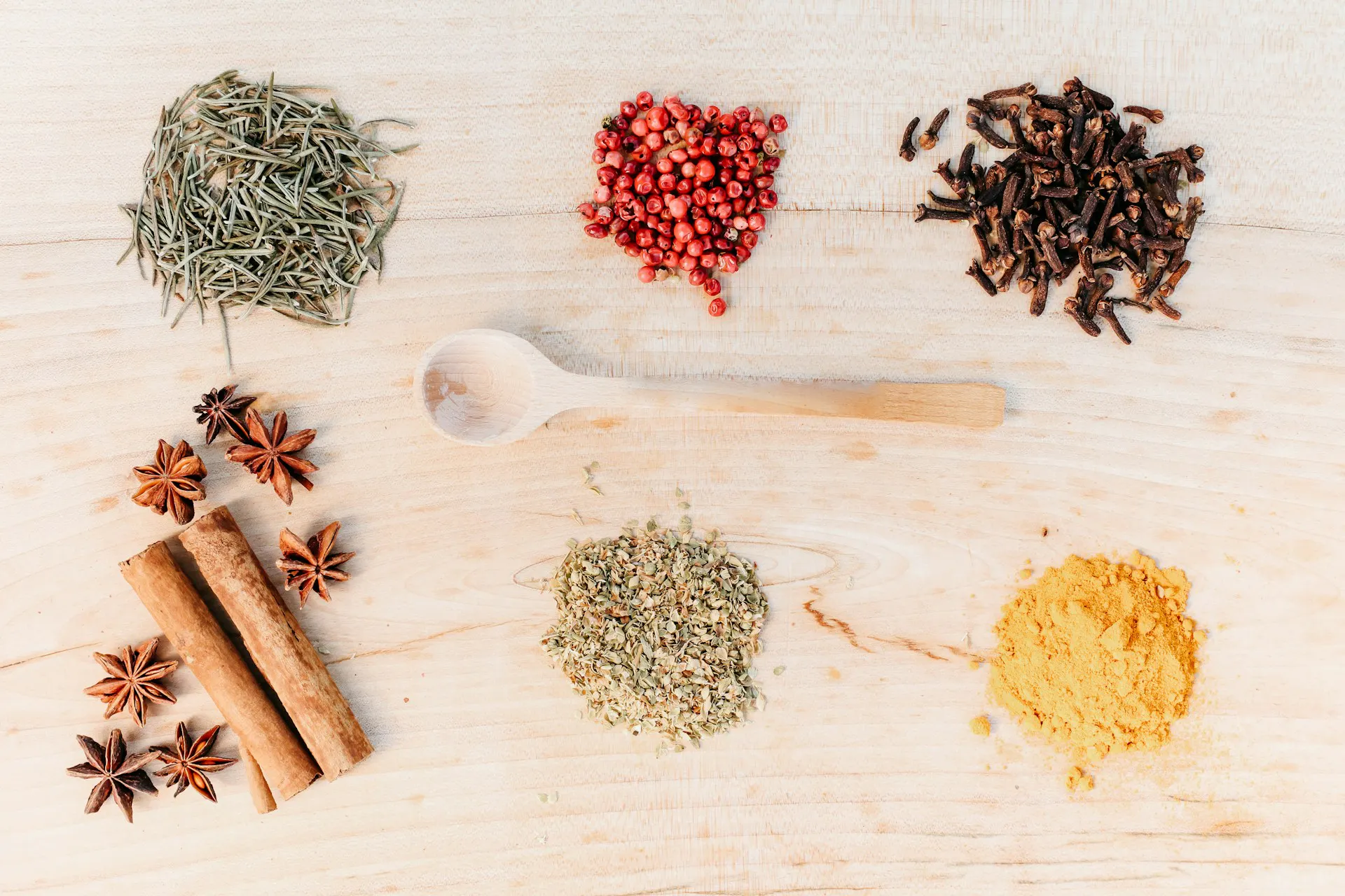 Various spices in piles on a wooden board