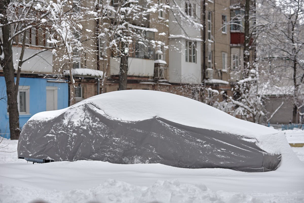 Voiture bâchée en hiver