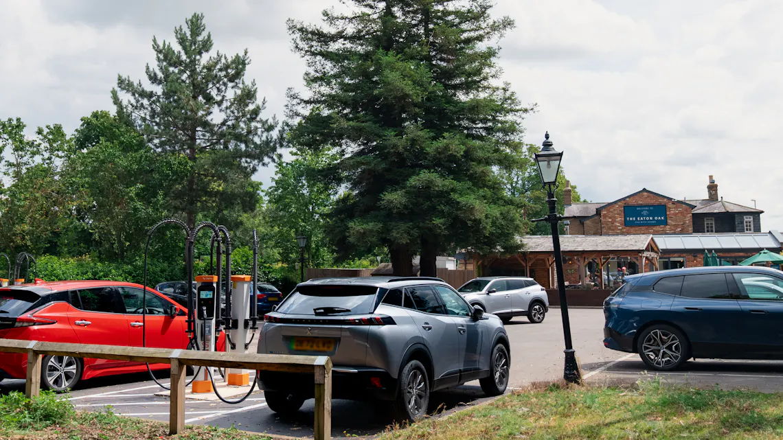 Electric cars charging at rapid charging stations at The Eaton Oak restaurant