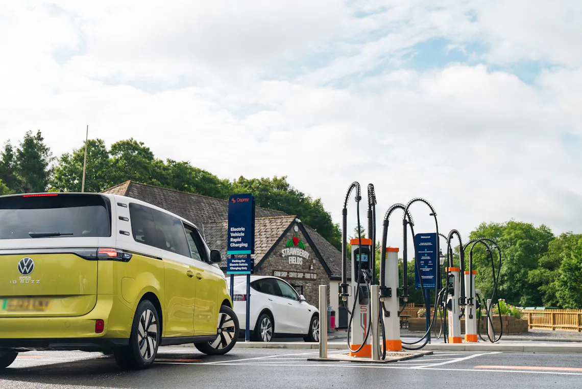 Electric camper van parking up to charge at Osprey EV rapid charging bay.
