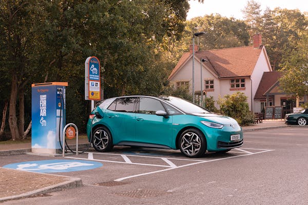 A teal VW ID.3 plugged into a 50kW rapid Osprey EV charging station outside a Marston's restaurant.
