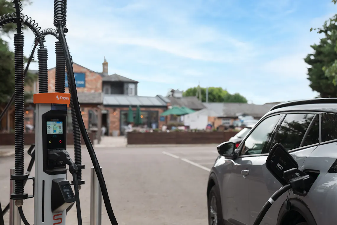 Electric car charging at Osprey EV charger in a pub car park.