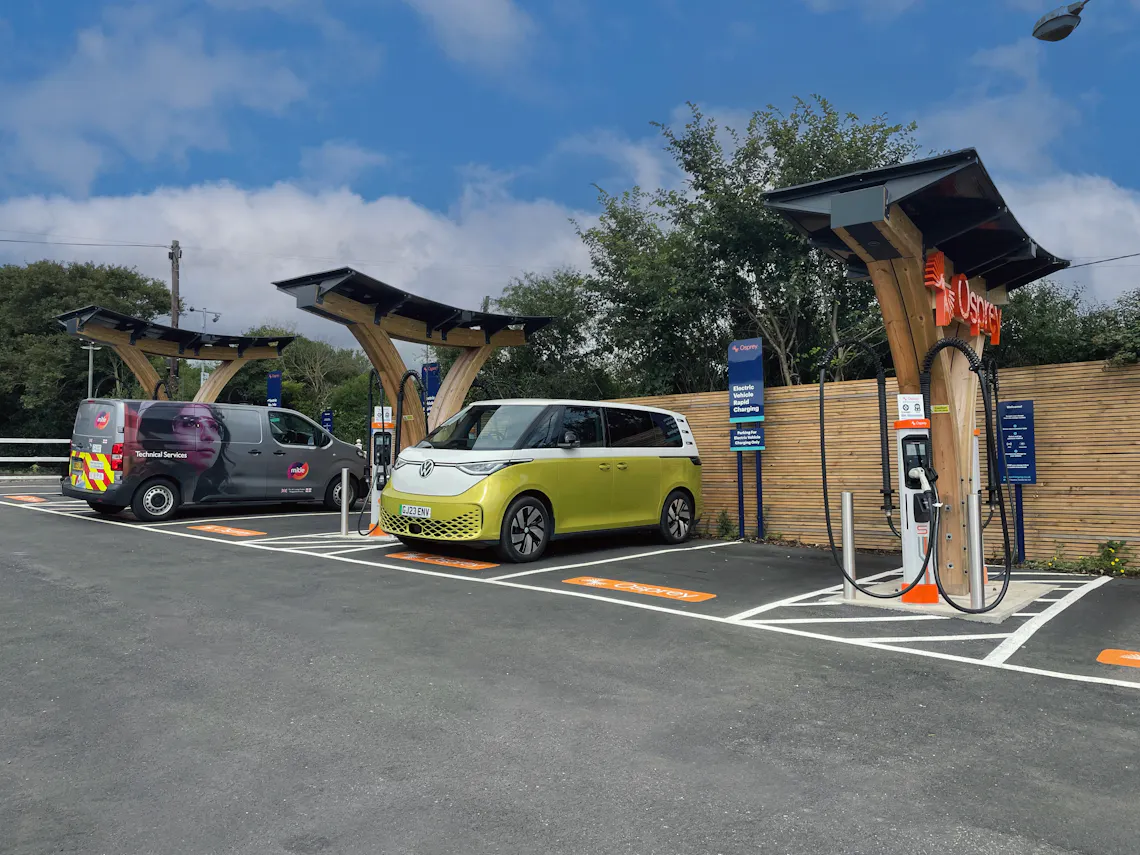 Two electric vans parked at an Osprey electric vehicle charging hub