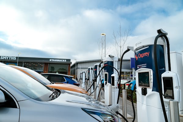 Electric cars charging at charging hub of Osprey EV rapid charge points