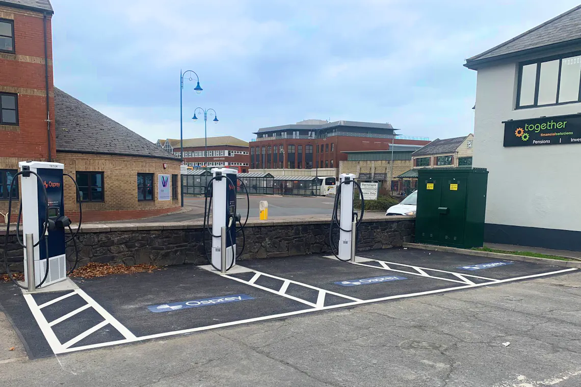 Three blue Osprey branded chargers in a carpark.