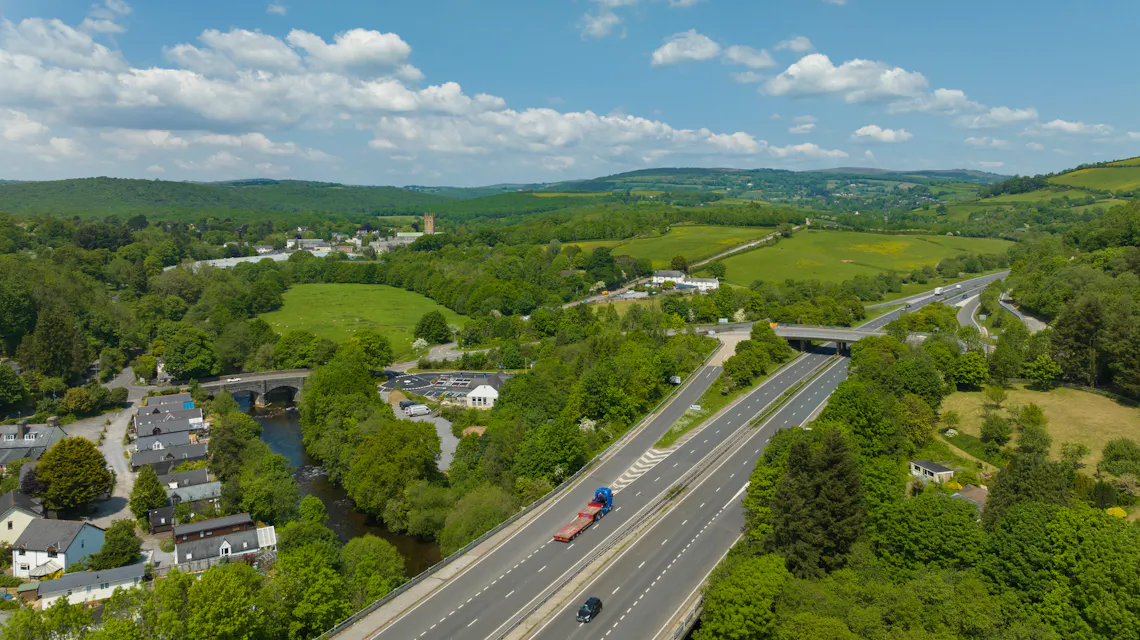 Overhead photo of a rapid charging hub located in the countryside next to a highway