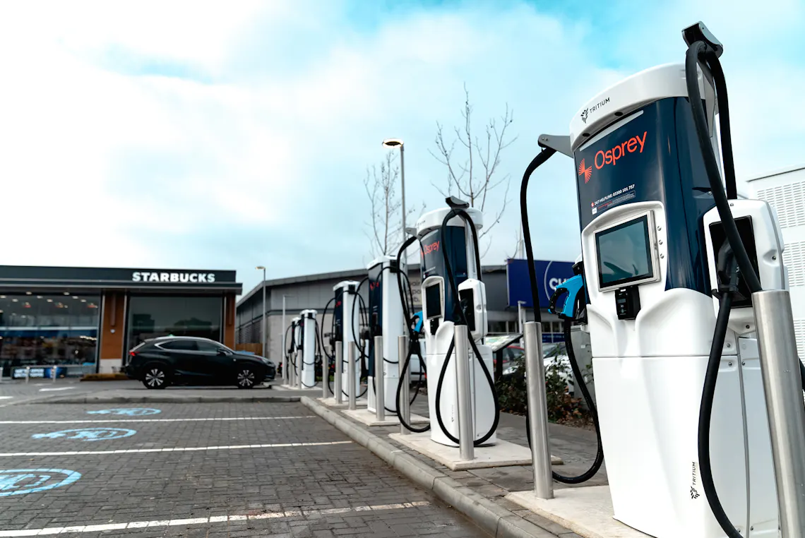 A charging hub of Osprey ev charging stations next to a Starbucks