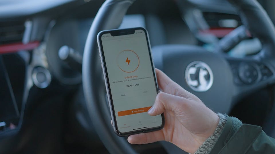 A hand holding a smart phone showing a charging session starting on the Osprey EV charging app
