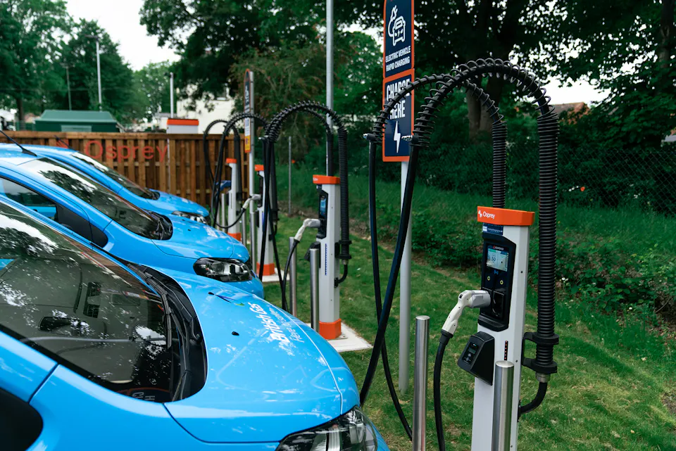 British Gas vans plugged into an ultra-rapid Osprey electric vehicle charging station