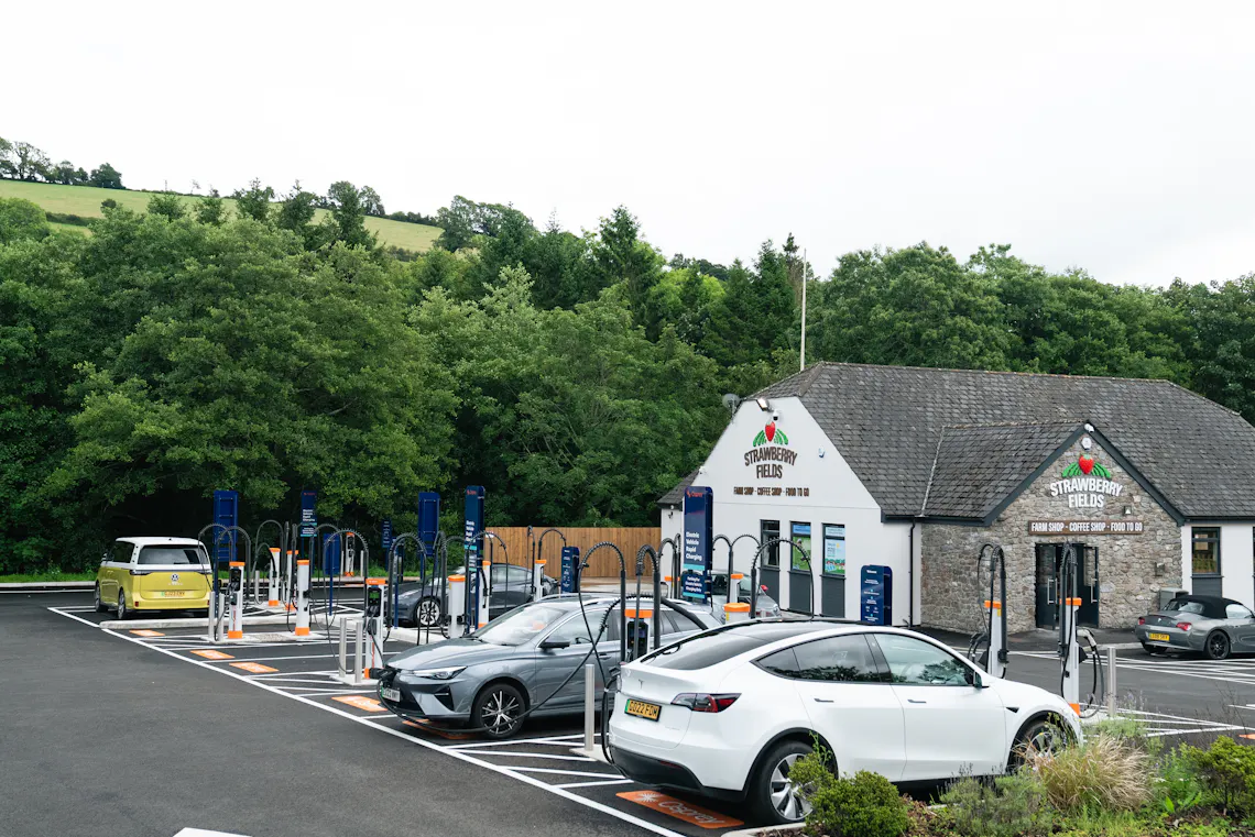 Electric cars charging at a large hub of Osprey EV chargers.