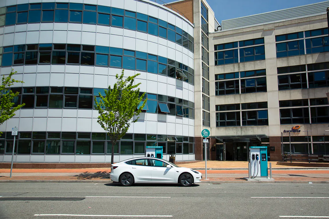 A Tesla plugged in to a Cardiff Council branded 50kW Osprey charging station next to a second charging station