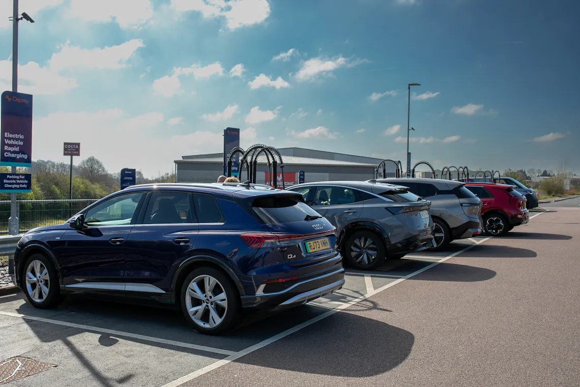 Electric vehicles plugged in at an Osprey charging hub