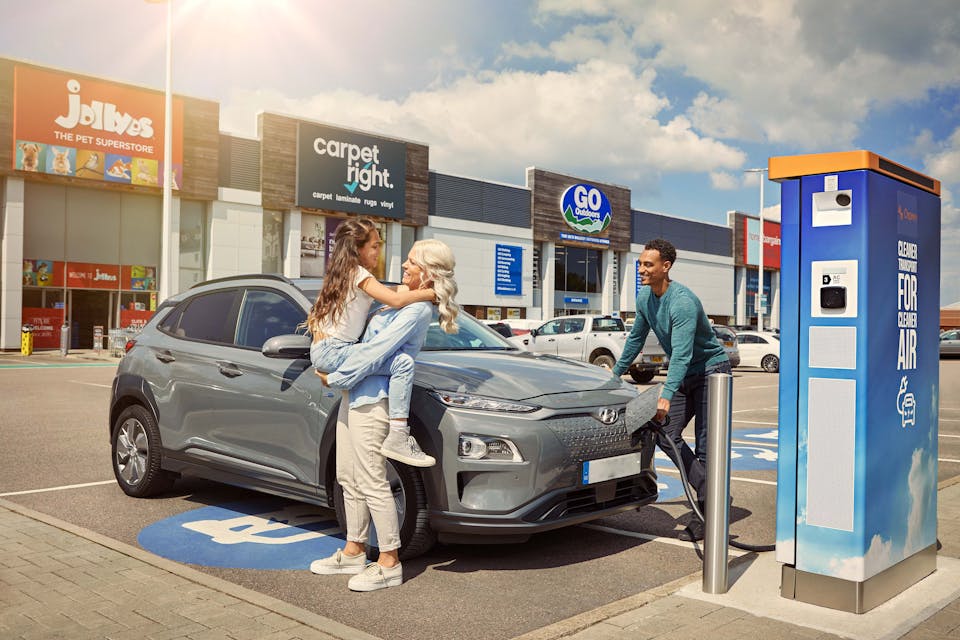 Family charging at a 50kW Osprey electric car charging station
