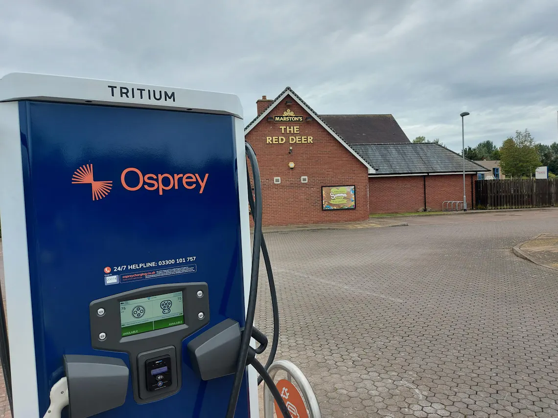 An Osprey branded Tritium chargepoint in front of a Marston's restaurant, The Red Deer.
