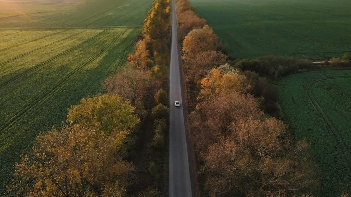 Aerial view Electric Car Driving on Country Road. 