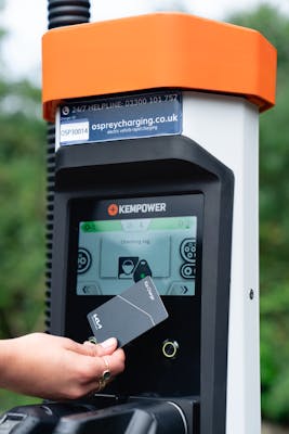 Person paying for their car charge by card at a Osprey EV rapid charger.