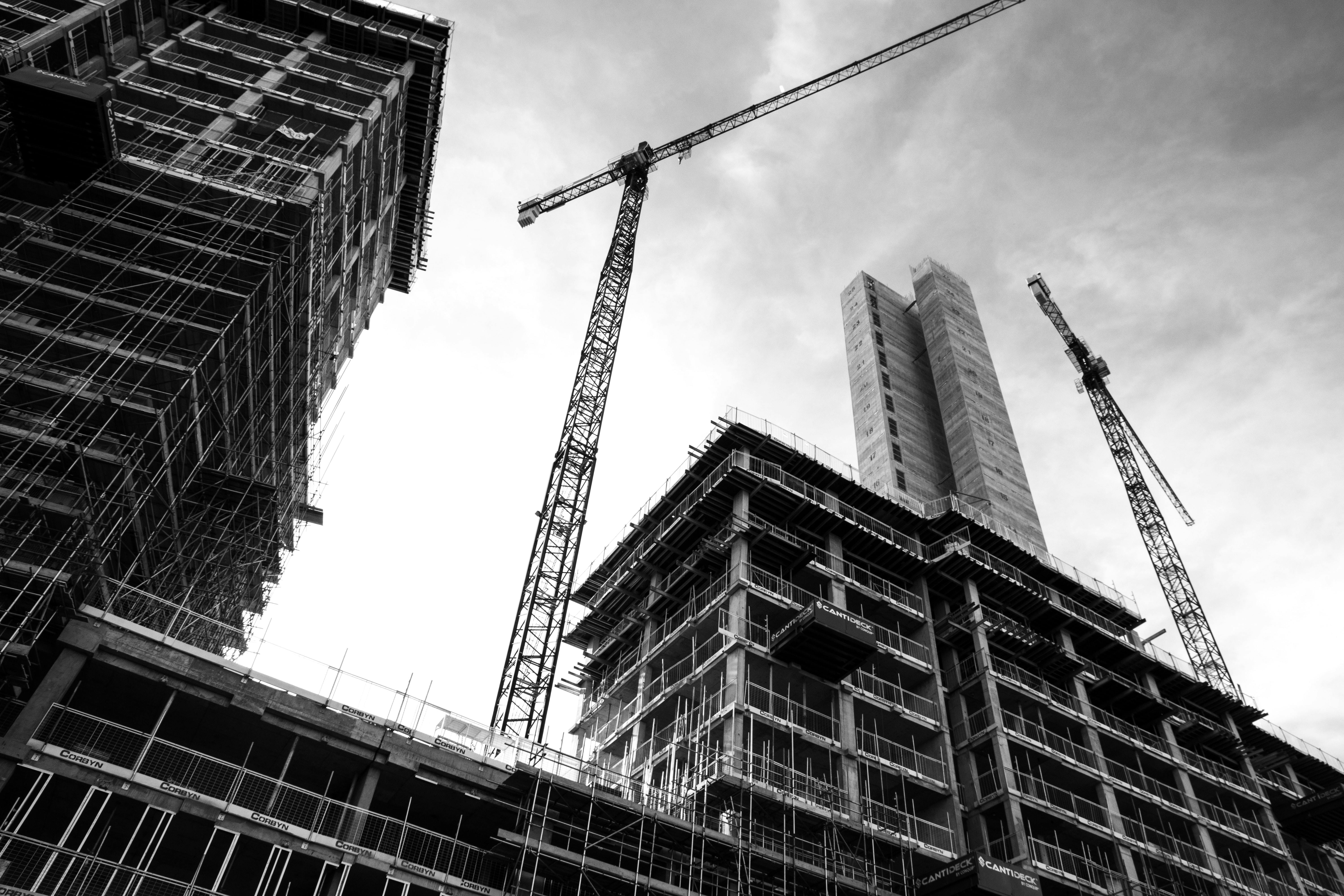Construction buildings with cranes nearby.