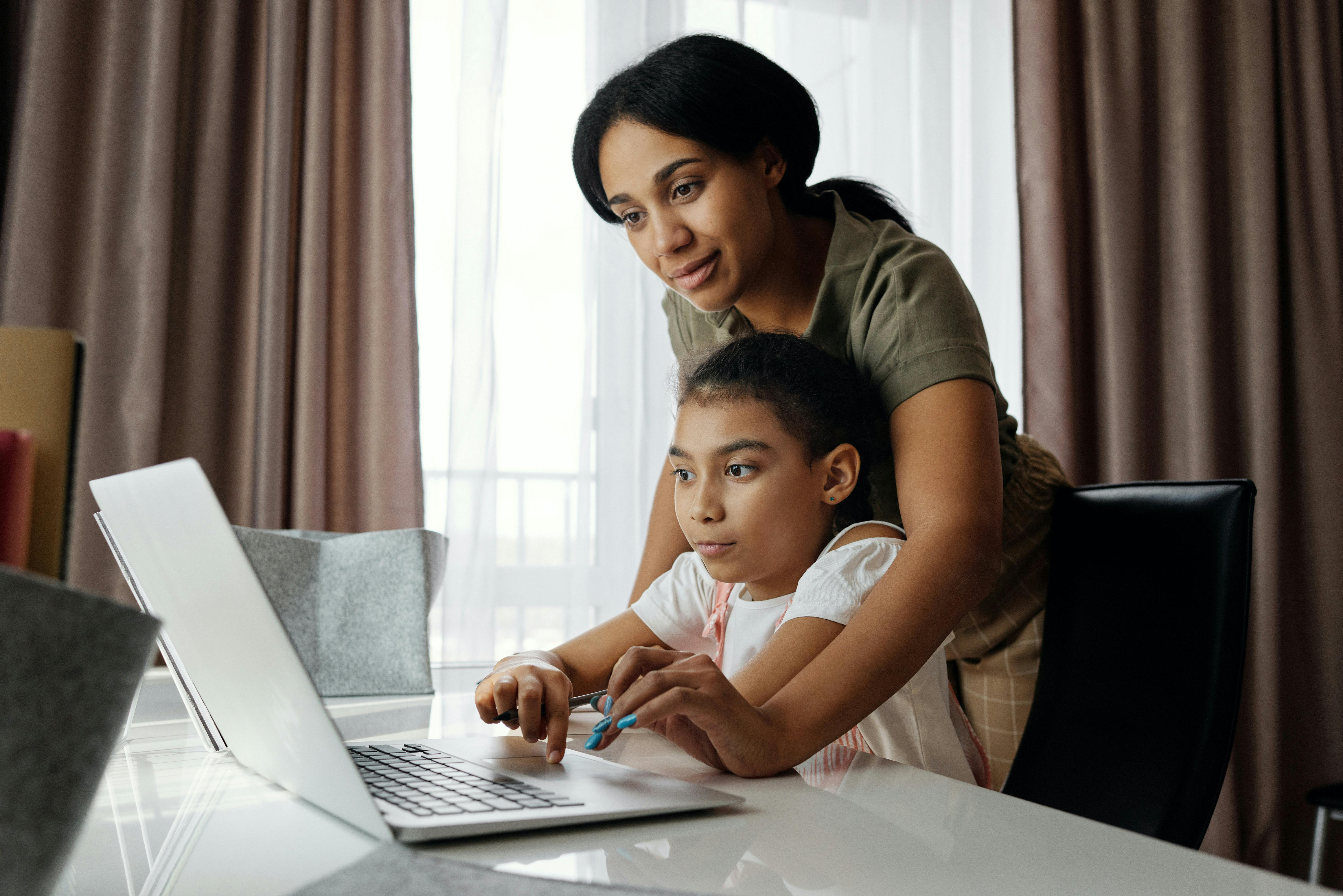 Adult and child learning online together.