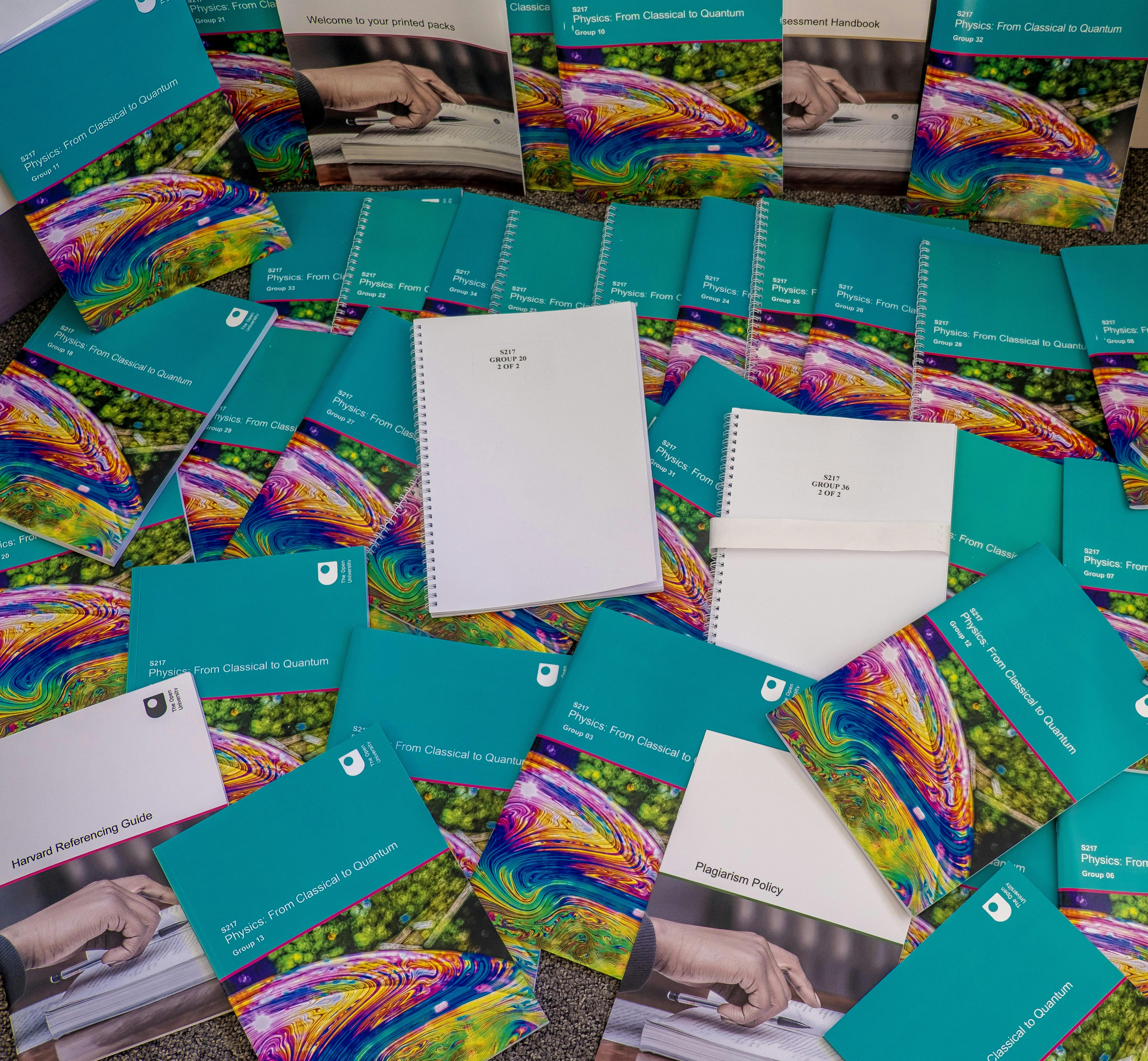 Several module material booklets scattered on a table.