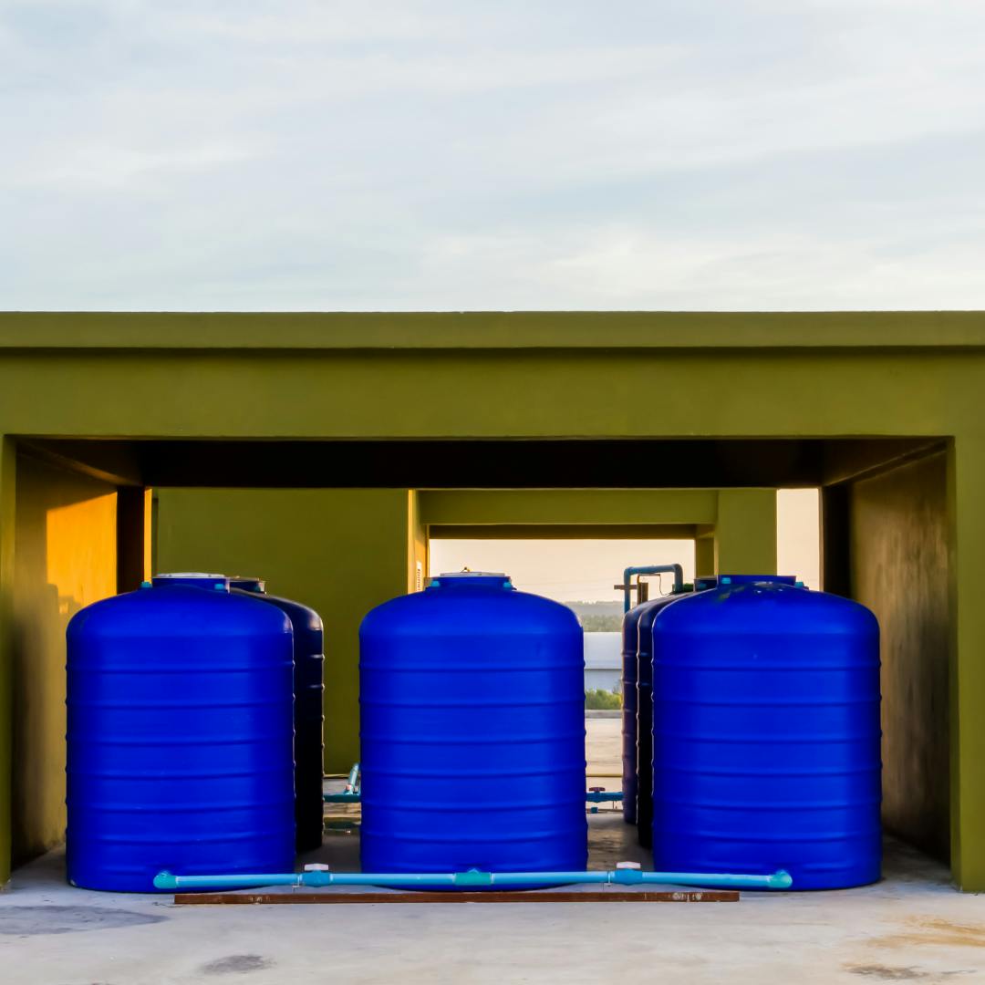 Three large blue barrels next to each other and linked