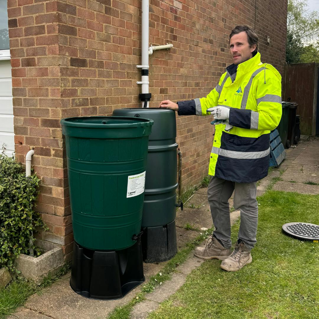Installer stood next to water butt
