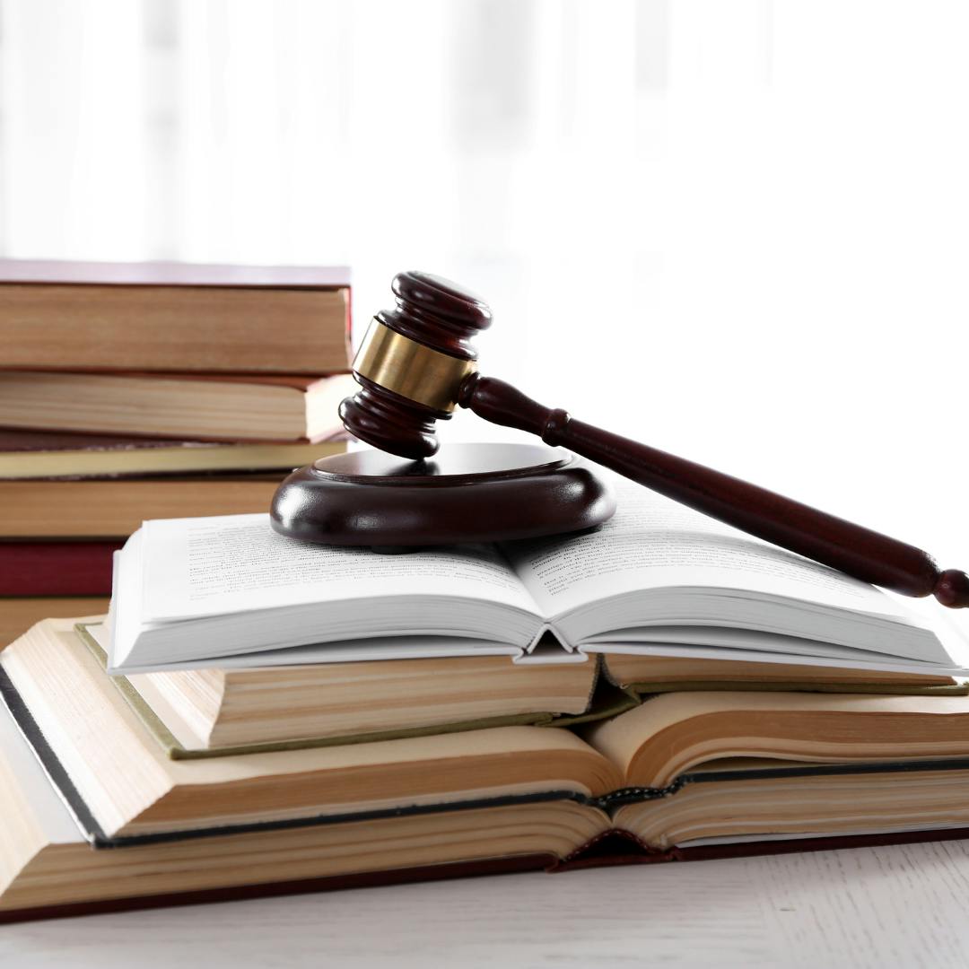 A gavel resting atop open books