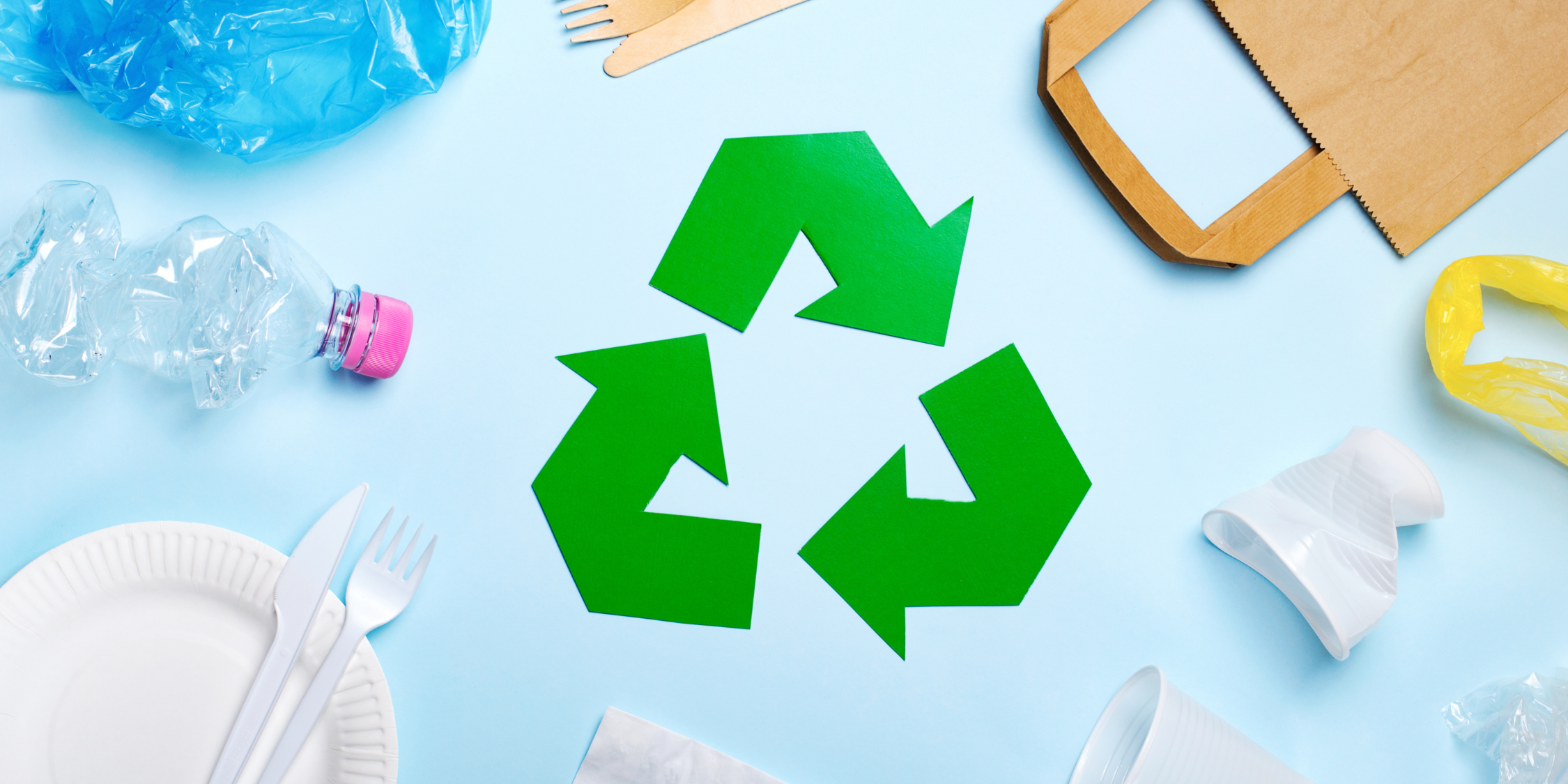 The recycling symbol in the centre of recyclable materials