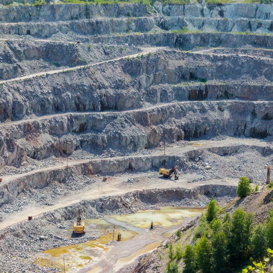 A large quarry with diggers in it