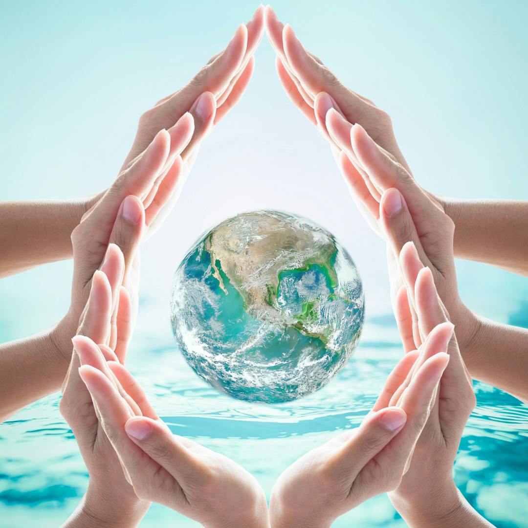 Hands in a water droplet shape surrounding a the earth
