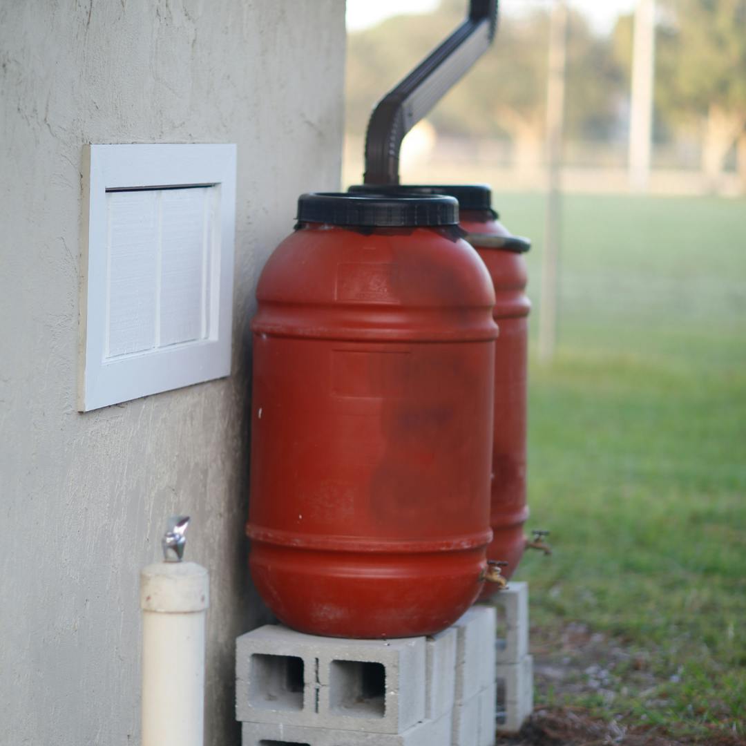 Red Water Butts elevated on concrete blocks