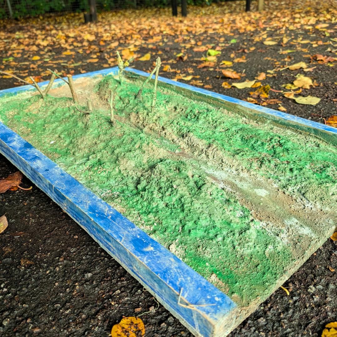 A concrete diorama meant to replicate a river flowing through a valley.