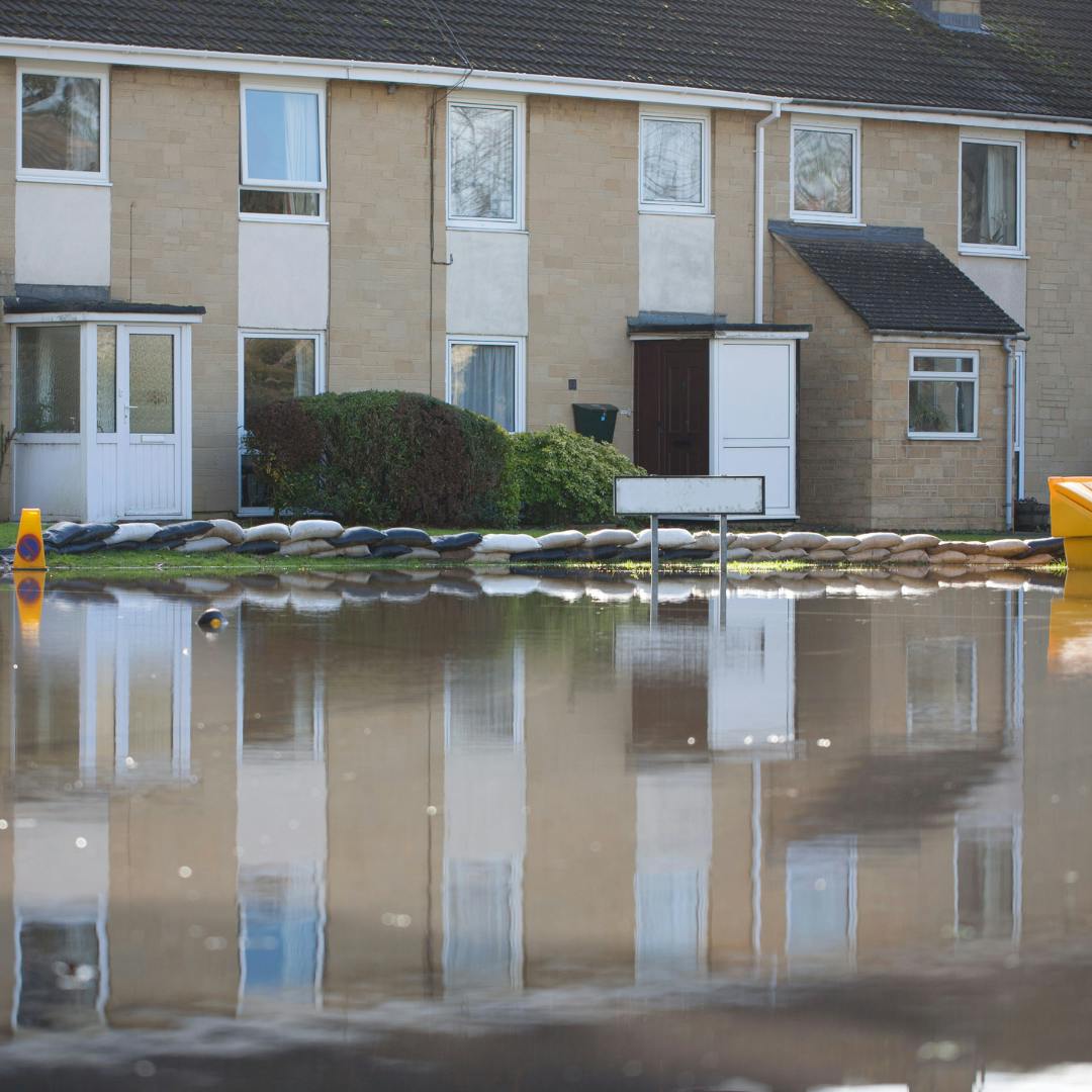 A row of terraced houses with the street in front of them flooded