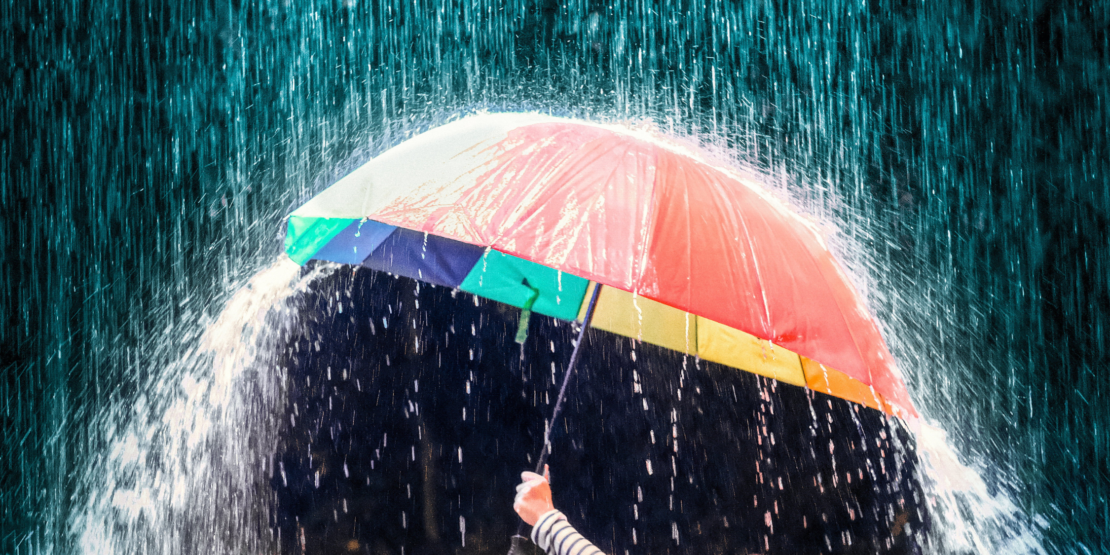 An umbrella deflecting heavy rain