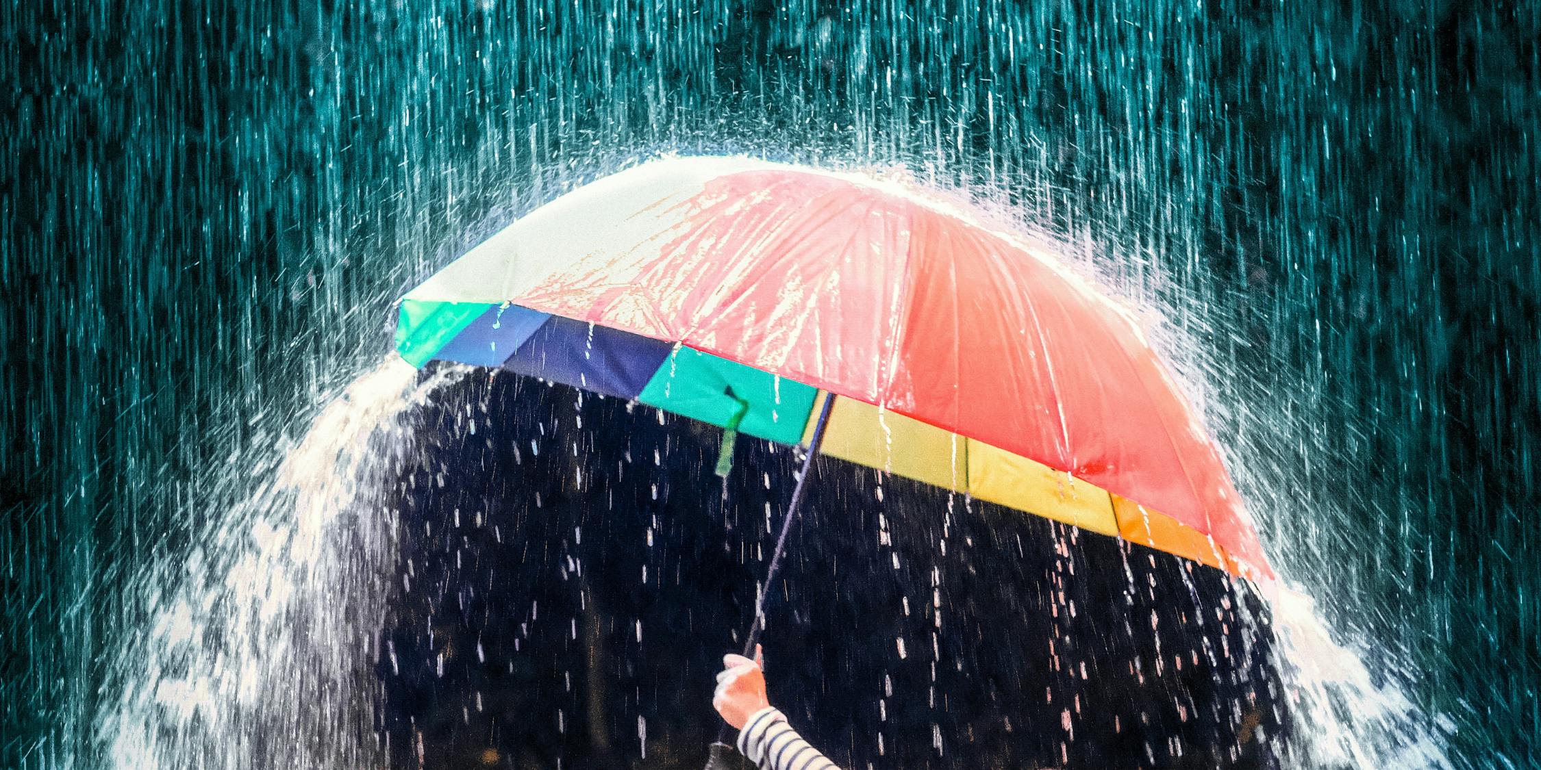 An umbrella deflecting heavy rain