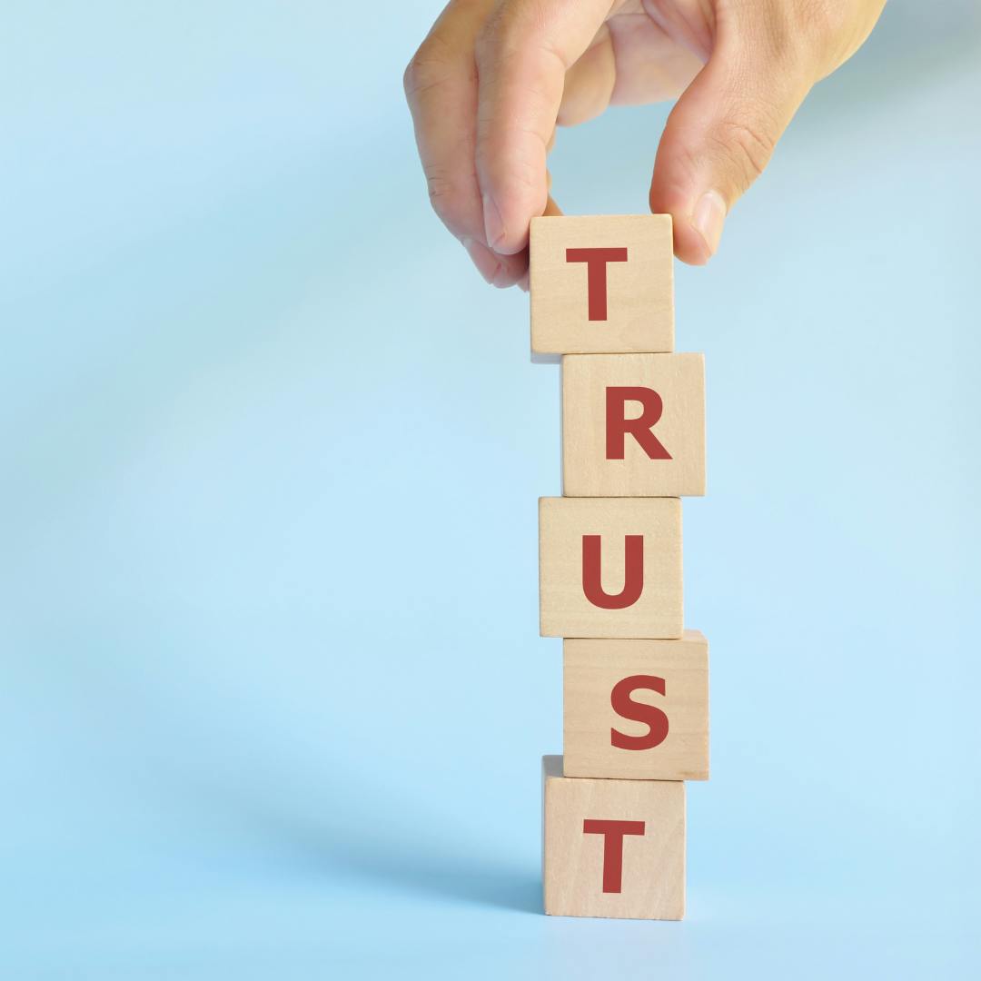 wood blocks that spell trust stacked vertically