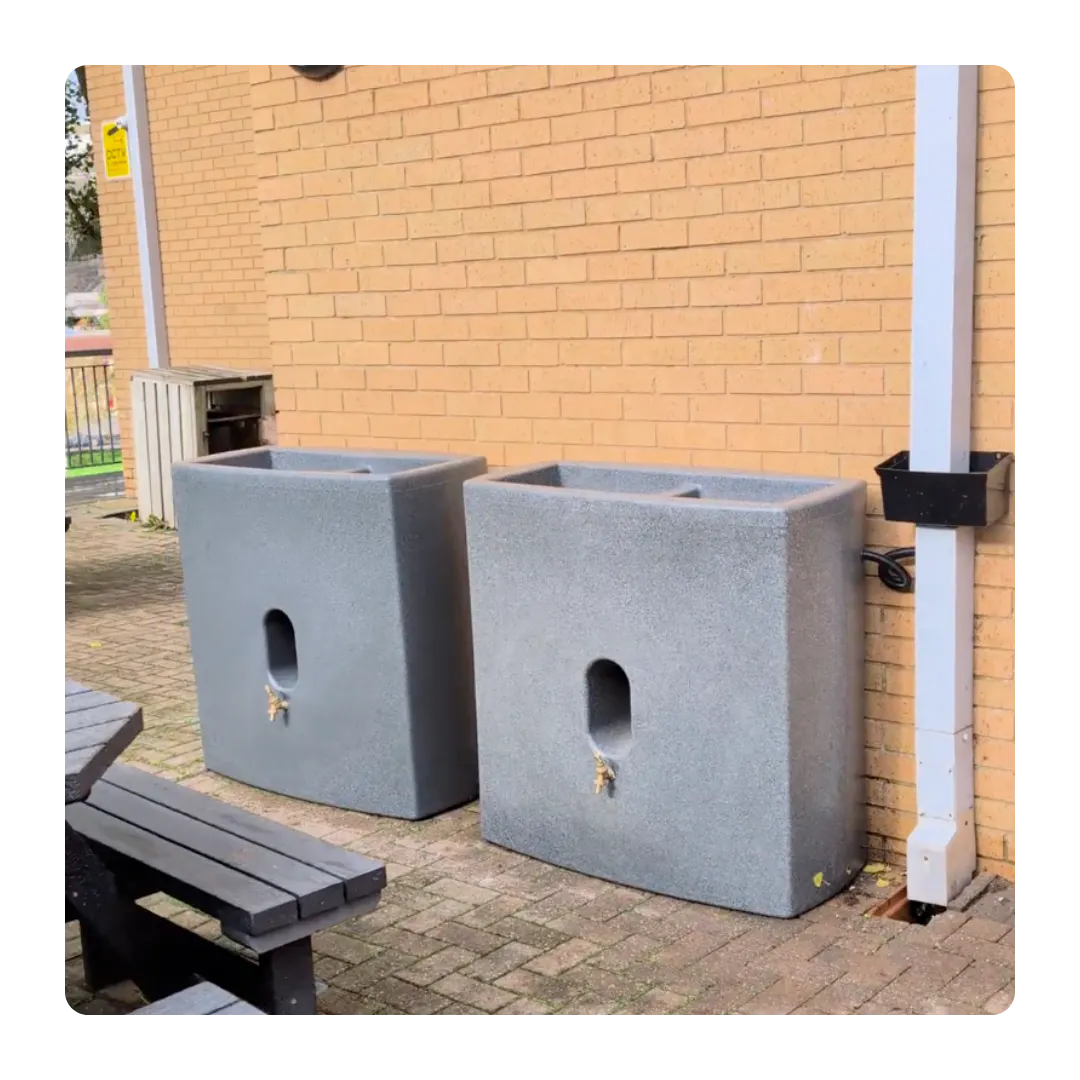 Two planters next to a white downpipe