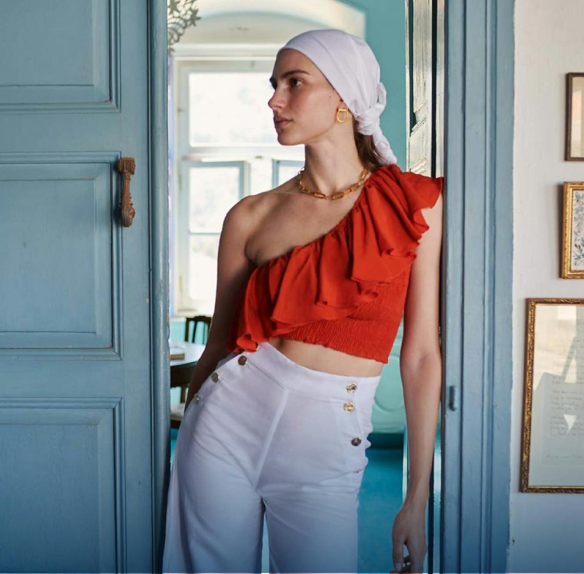 Woman wearing red Paolita top and white Paolita trousers 