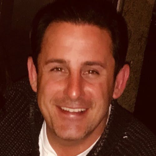 A light-skinned man with short brown hair.