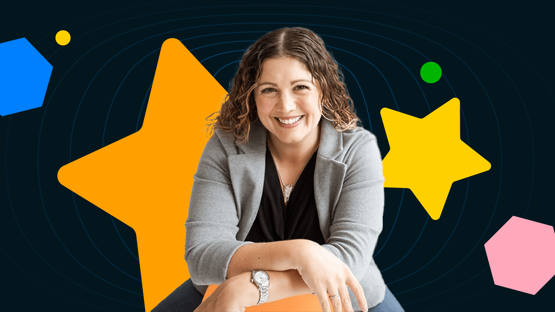 Brand Trifecta founder Kate DiLeo wears a gray blazer and black shirt against a black background with a variety of colorful shapes.