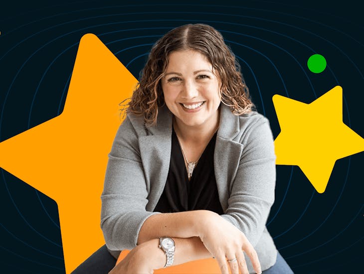 Brand Trifecta founder Kate DiLeo wears a gray blazer and black shirt against a black background with a variety of colorful shapes.
