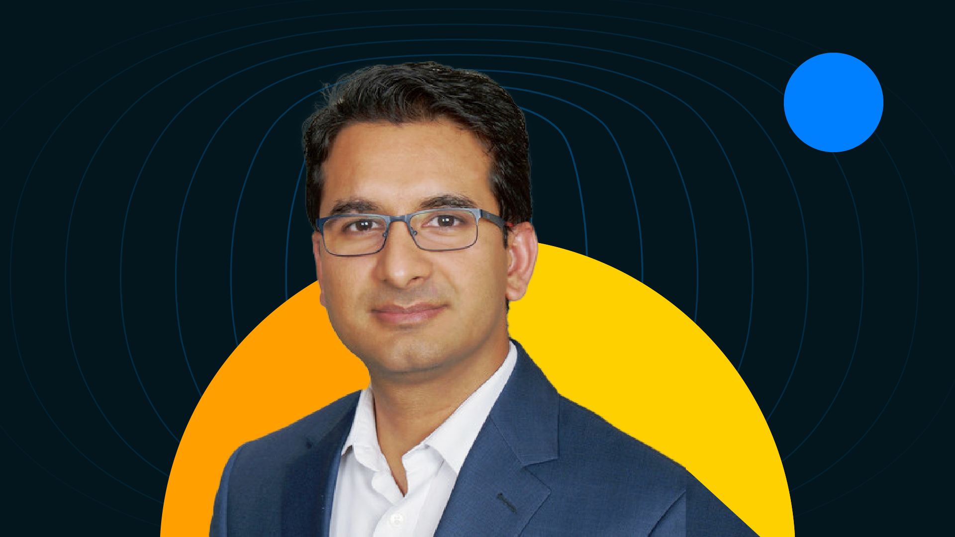 Anshul Verma, founder of Cynoteck, wears a suit and glasses against a yellow-orange half-circle.