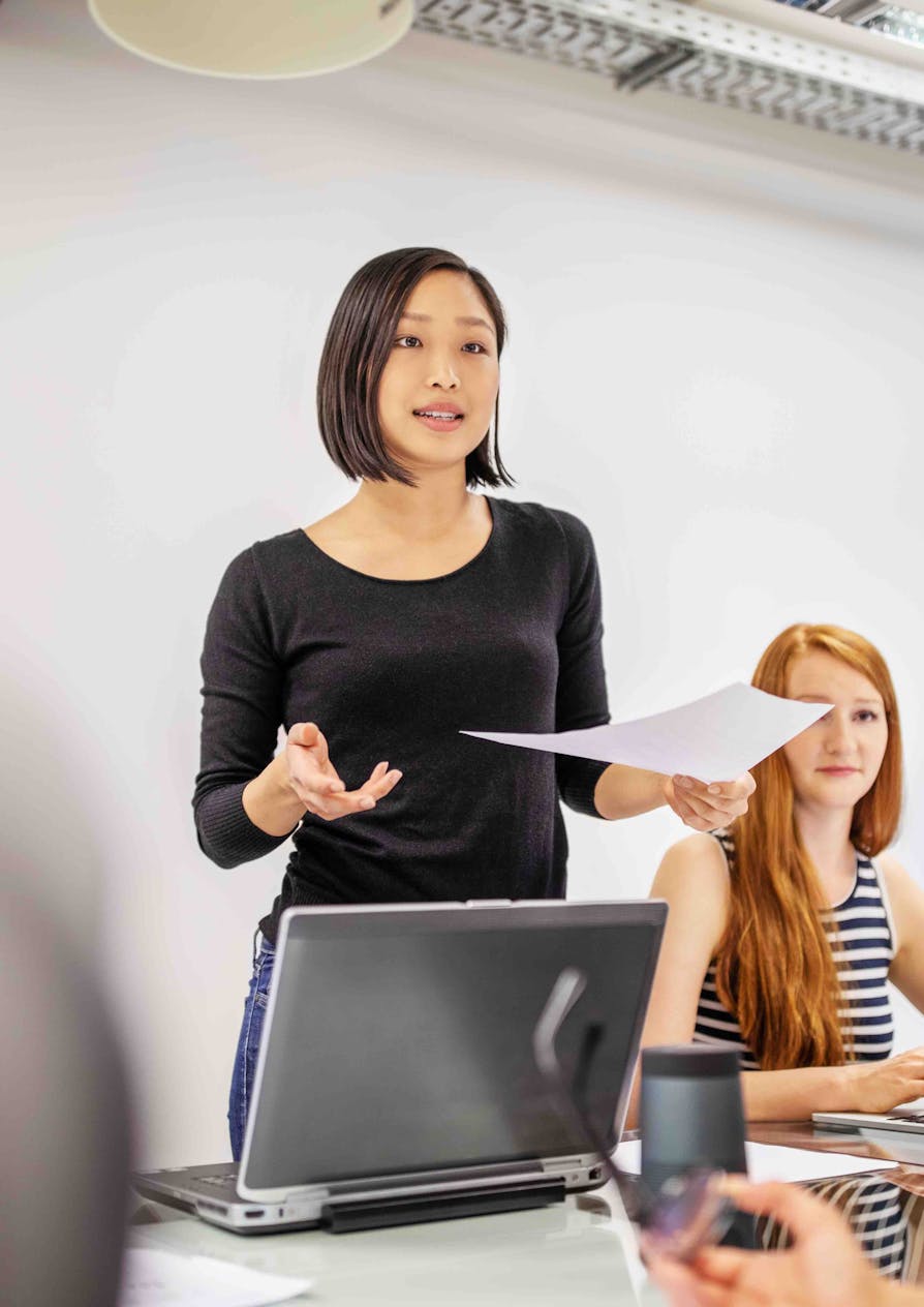 A woman talks in front of a laptop as Overpass evolves the world of work.
