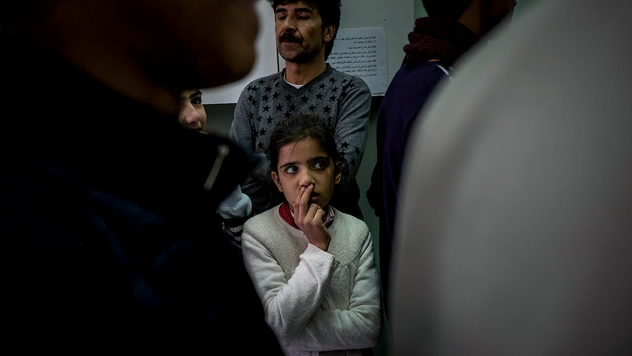 Migrants - refugees and asylum-seekers line up to receive a free meal at Caritas in Athens-Greece, Jodi Hilton 2018