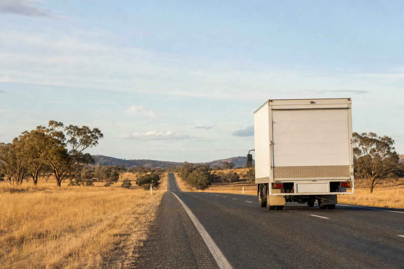 White courier truck on an Australian highway between cities
